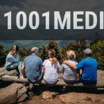 group of people sitting on rocks overlooking mountain